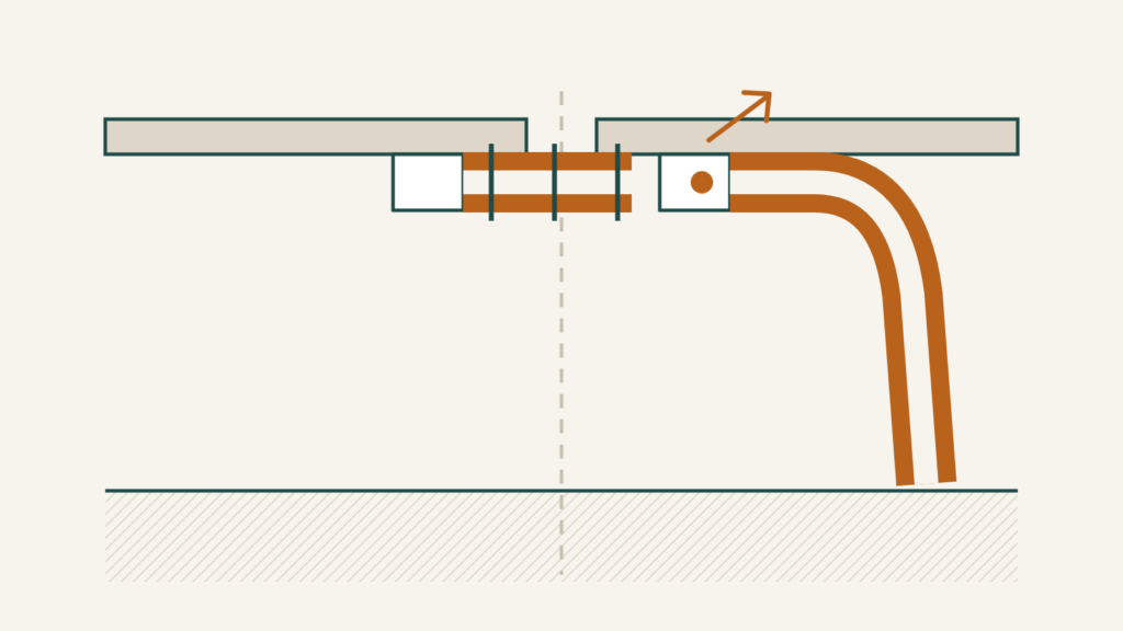Mobile home crossover duct running between two floor sections with one end disconnected from its collar